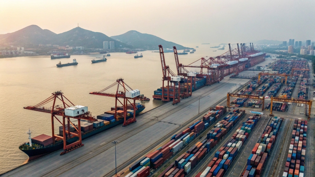 alt with keywords: A busy port in China with cargo ships and containers, ready to transport goods like baby strollers internationally